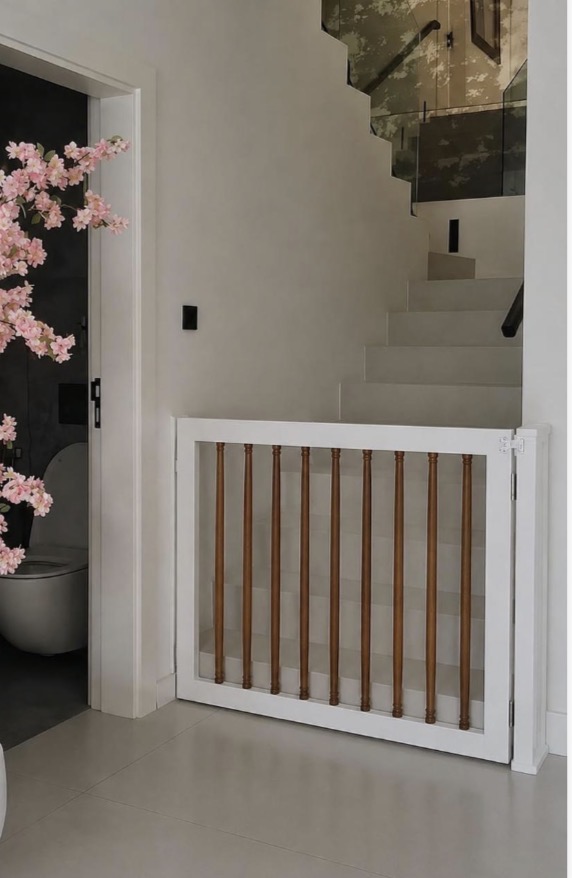The Windsor Gate with a painted white frame and warm wood spindles